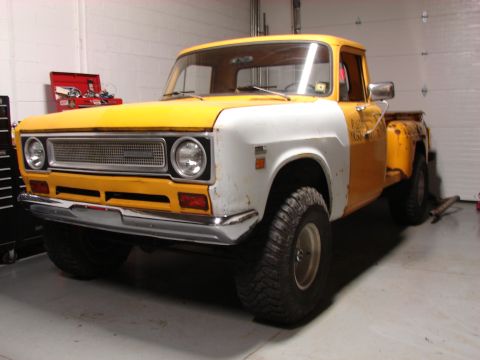 1971 International School Bus - This International pickup truck appears to be undergoing some bodywork, with mismatched paint on the fenders and doors.