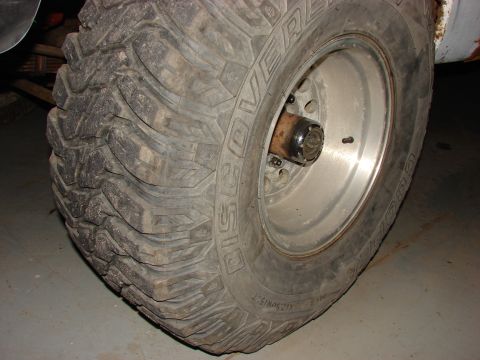 1971 International School Bus - A close-up view of a off-road tire and its silver wheel, showing the detailed tread pattern.