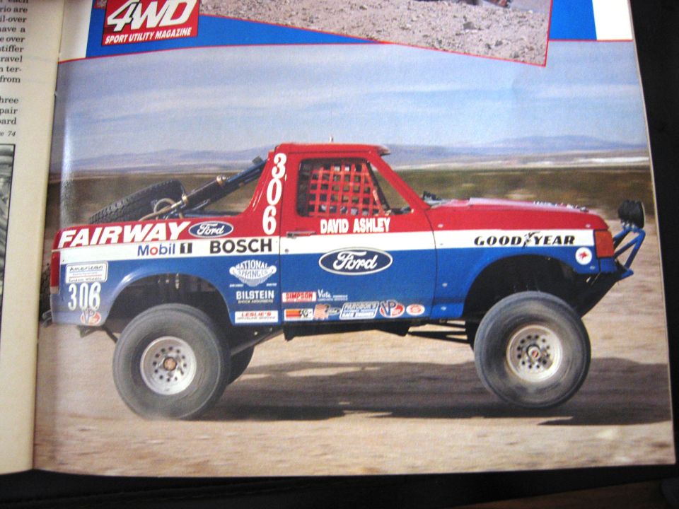 1986 Ford Bronco race truck with "FAIRWAY", "Ford", "Mobil 1", "BOSCH", "NATIONAL", "BILSTEIN", "DAVID ASHLEY", and "GOOD YEAR" decals
