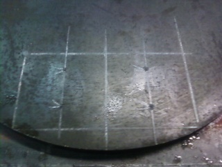 1995 Ford Bronco - Close-up of coil cup shims with a grid pattern marked on the surface.