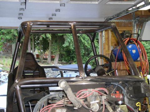 1979 Ford Bronco - This custom-built buggy features a prominent roll cage, a steering wheel, and a view of the engine compartment with red wiring.