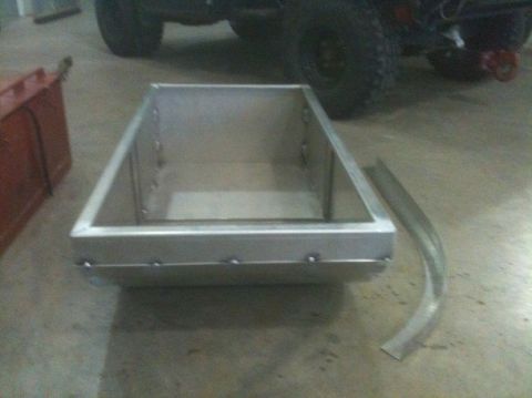 1986 Chevrolet Blazer - A metal box sits on a concrete floor with a vehicle tire visible behind it.