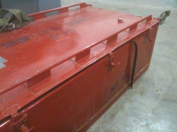 Red metal storage container with latches and handles