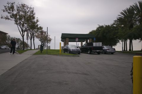 2006 Cadillac STS - A dark sedan, identified as a 2006 Cadillac STS, is parked in a lot near a covered pavilion.