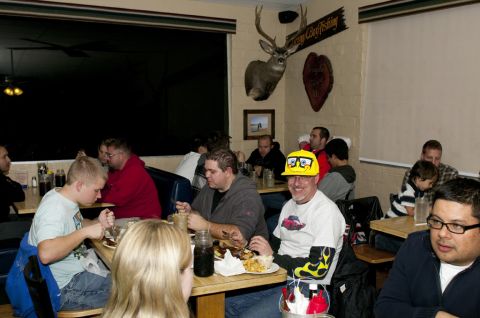 2006 Cadillac STS - People gathered for a meal in a casual dining establishment, with a mounted deer head as decor.