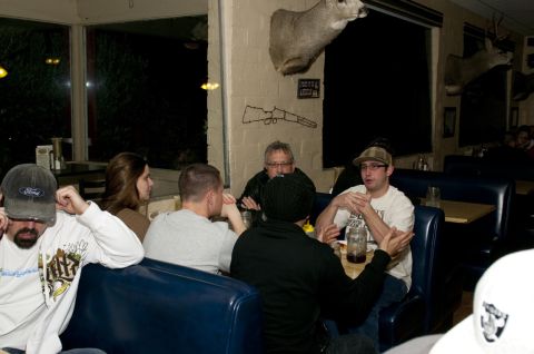 2006 Cadillac STS - People gathered around tables in a restaurant, with taxidermied deer heads visible.