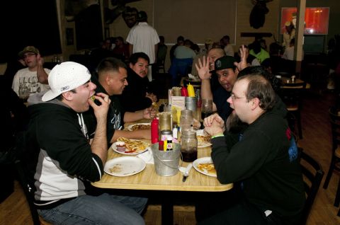2006 Cadillac STS - Friends gather around a table, enjoying food and conversation in a casual dining setting.