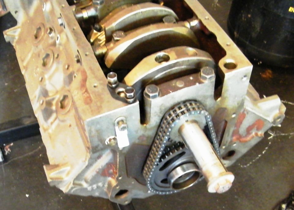 Engine block showing crankshaft bearings and timing chain assembly