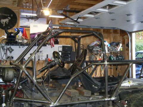 1979 Ford Bronco - Interior view of a custom-built off-road vehicle, showing its extensive roll cage and basic seating.