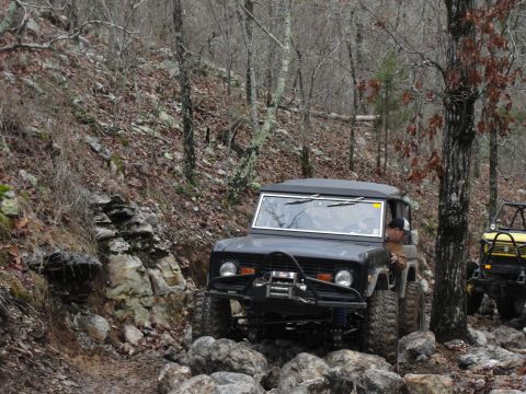 1967 Ford Mustang - A black 1966 Ford Bronco tackles a challenging rocky trail, with another off-road vehicle visible behind it.