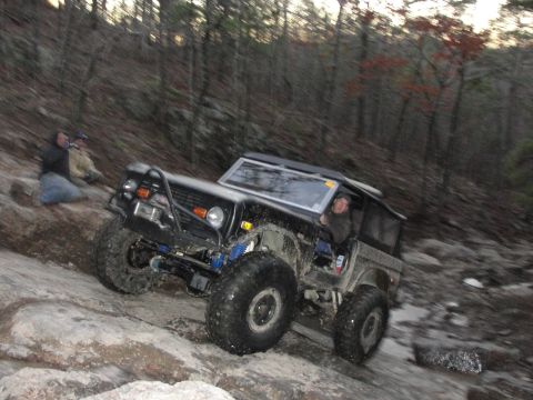 1967 Ford Mustang - This modified SUV is navigating a challenging rocky terrain during an off-road excursion.