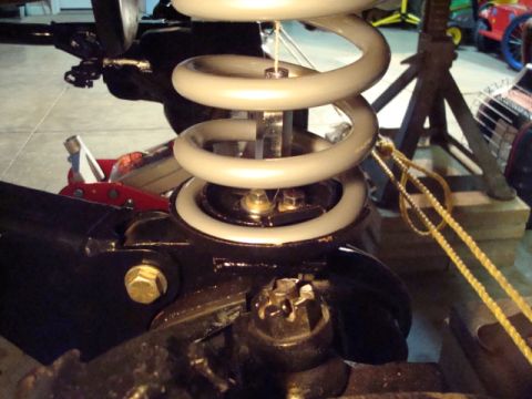 1995 Ford Bronco - Suspension coil spring and axle components are visible in this close-up shot, with a yellow rope attached.
