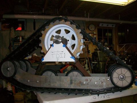 1987 Suzuki Samurai - Custom snow track assembly with a large cogwheel and multiple road wheels is shown.