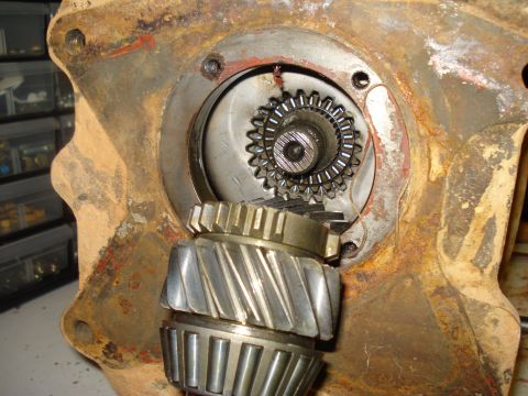 1991 Ford Bronco - Close-up view of internal gears and bearings within a rusty drivetrain component.