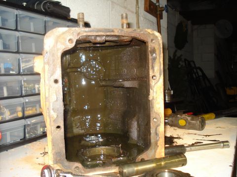 1991 Ford Bronco - This is a close-up view of a dirty, open differential housing, likely removed for repair or inspection.