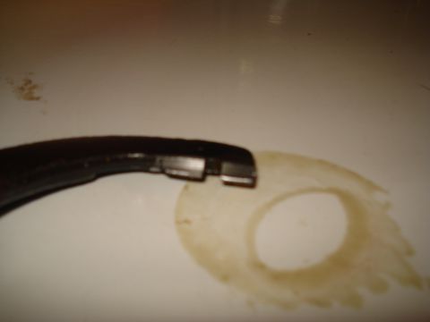 1991 Ford Bronco - A close-up view shows a dark metal component next to a stained gasket, likely from a vehicle's drivetrain.