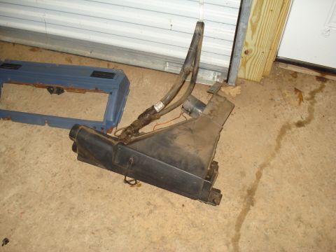 1985 Ford F-150 - HVAC blower motor housing and ducting assembly, likely from an older truck or car, sits on a concrete floor.