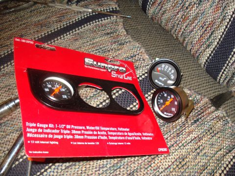 1985 Ford F-150 - A Sunpro triple gauge kit, including oil pressure, water/oil temperature, and voltmeter gauges, is displayed with its packaging.