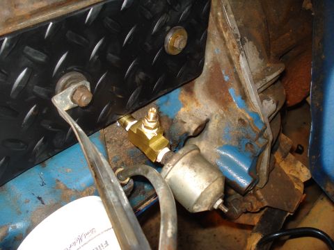 1985 Ford F-150 - Close-up of an engine oil filter and a brass fitting, with visible text from a Ford Motor Company filter.