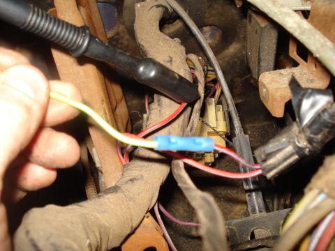 1985 Ford F-150 - Close-up of automotive wiring harness with a hand making a connection.