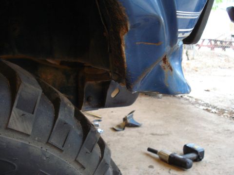 1985 Ford F-150 - The wheel well and fender show significant rust damage, indicating a need for repair.