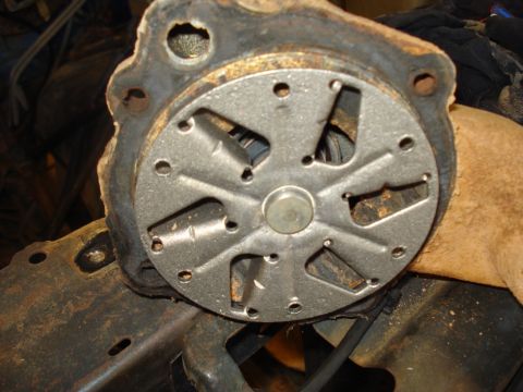 1985 Ford F-150 - Close-up of a water pump impeller, showing its metal fan and housing.