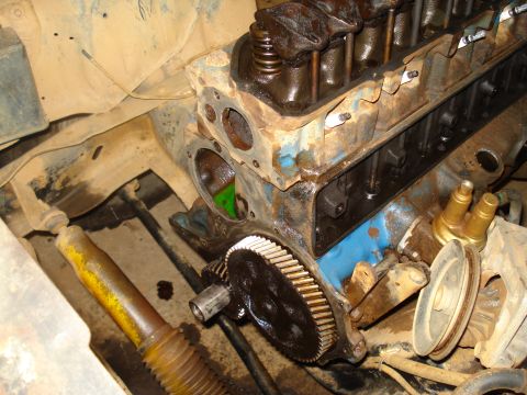 1985 Ford F-150 - Close-up view of an engine block, showing gears and spark plug wires, with visible signs of wear and tear.
