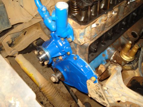 1985 Ford F-150 - Close-up of a newly painted engine part installed on a V8 engine.