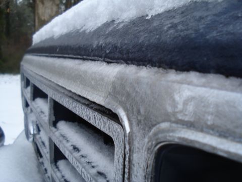 1994 Ford F-350 - Front grille of a 1994 Ford F-350 covered in ice and snow during winter.