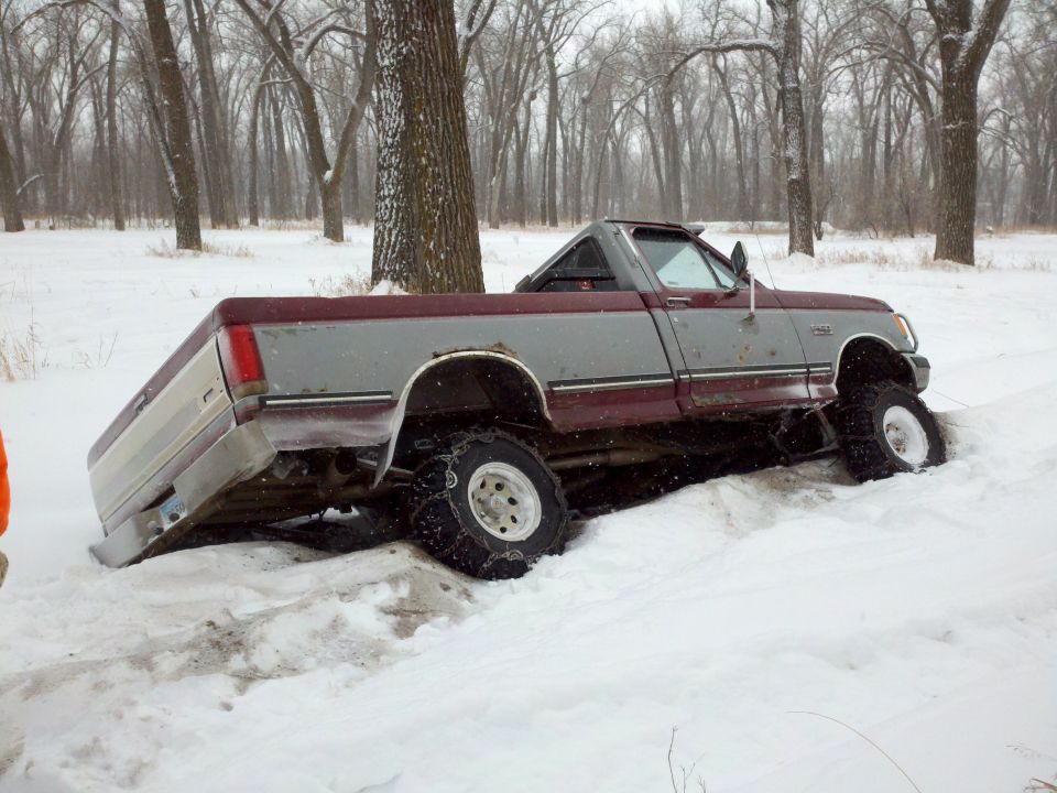 1988 Ford F-150 stuck in snow with its rear end low and front wheels high