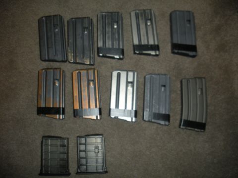 1996 Ford Bronco - A collection of firearm magazines, some with black tape around the base, are displayed on a textured surface.