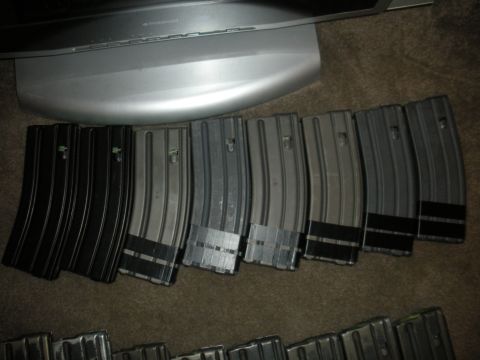 1996 Ford Bronco - A collection of firearm magazines is displayed on a carpeted surface, partially obscured by a monitor stand.