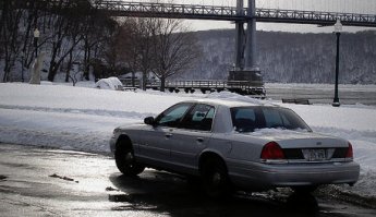 2000 Ford Crown Victoria - A silver 2000 Ford Crown Victoria is parked on a snowy day near a bridge.