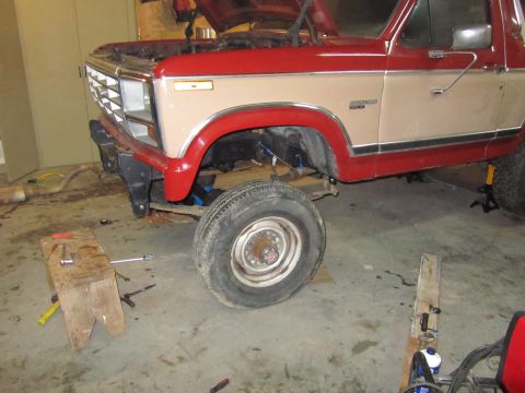 1984 Ford Bronco - This Ford Bronco is undergoing front-end repairs in a workshop setting.