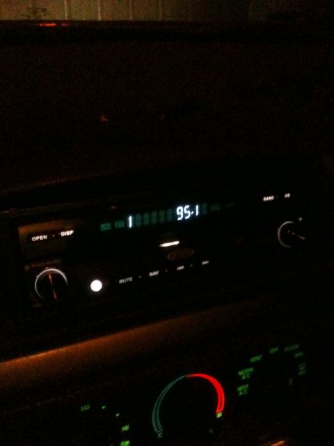 1993 Ford Bronco - The illuminated dashboard displays the radio frequency and various control buttons in the dark.
