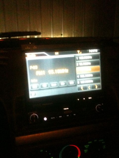 1993 Ford Bronco - The infotainment screen of a car shows radio station presets and the current time.