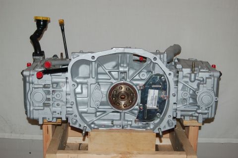 2000 Subaru Forester - This Subaru engine is mounted on a wooden crate, showing the front of the engine with the transmission bell housing removed.