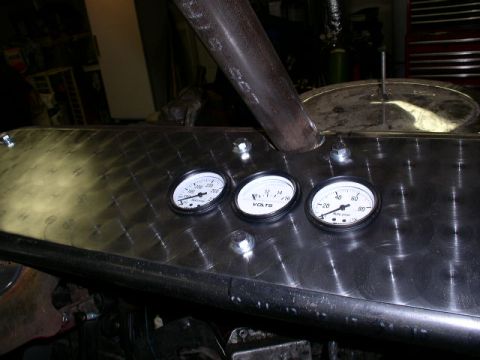 1979 Ford Bronco - A close-up view of a custom dashboard three gauges and a metal panel.