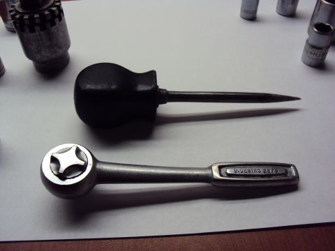 1965 Ford Mustang - A set of tools including a ratchet with "IND ESTRO 2876" visible and a pointed screwdriver.