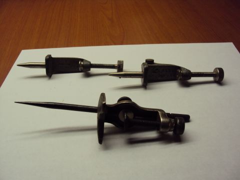 1965 Ford Mustang - Three vintage marking gauges are displayed on a white surface with a wooden background.