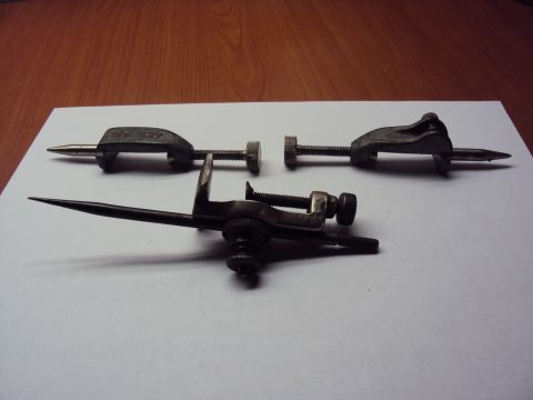 1965 Ford Mustang - Three metal marking gauges are displayed on a white surface, with a wooden background.