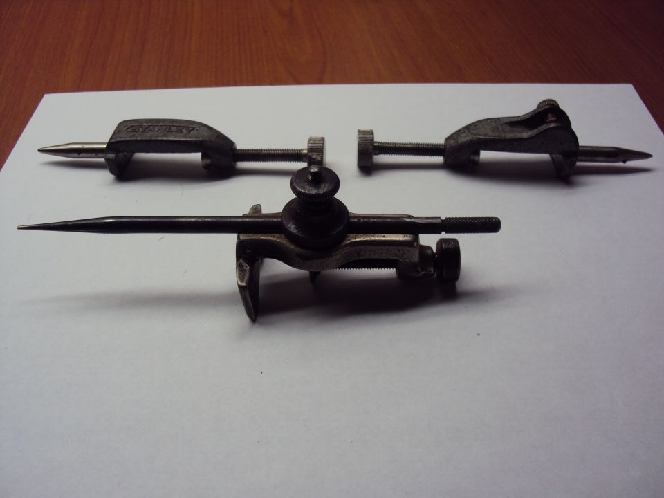 Two antique Stanley steel scribe/trammel point tools on white paper