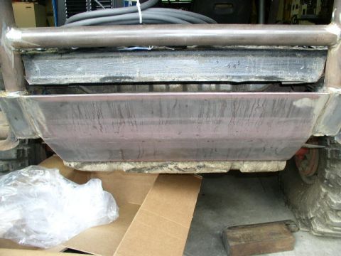 1979 Ford Bronco - Close-up view of a custom skid plate and frame components on a modified vehicle.