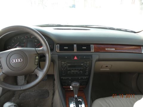 2000 Audi A6 - The interior of a 2000 Audi A6 features wood trim and a multi-function steering wheel.