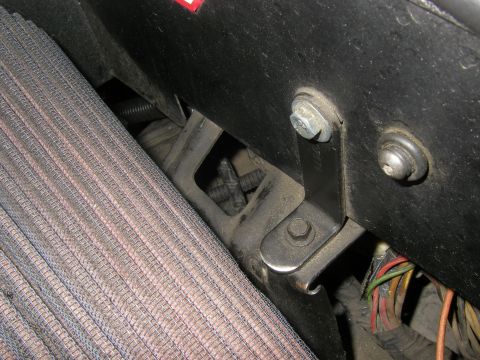 1990 Ford Bronco - Detail shot of engine bay components, including an air filter and various wires and brackets.