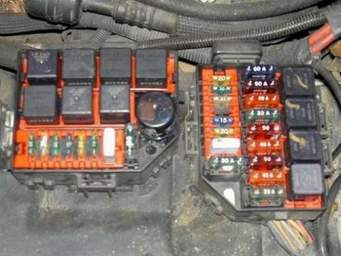 1990 Ford Bronco - Automotive fuse and relay panel showing labeled amperage fuses (20A, 30A, 40A, 50A) and several black relays in an orange holder.