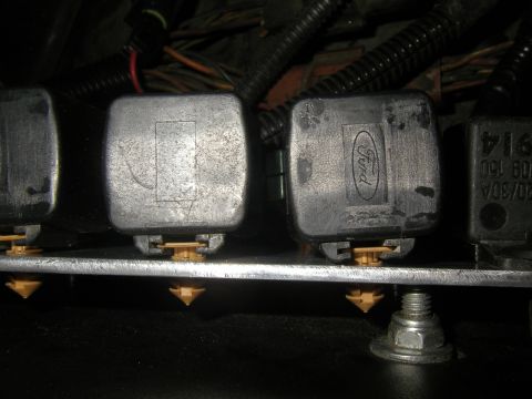 1990 Ford Bronco - Close-up of automotive relays, one clearly displaying the Ford logo, indicating a component from a Ford vehicle.