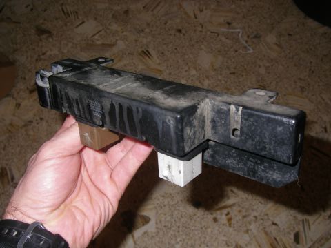 1990 Ford Bronco - Automotive relay module with two connectors, held by a hand.