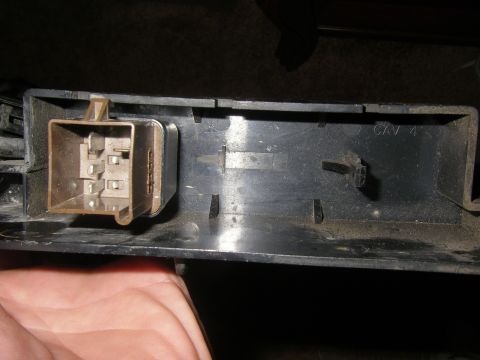 1990 Ford Bronco - A close-up view shows a brown relay socket with visible metal prongs, likely from a vehicle's electrical system.