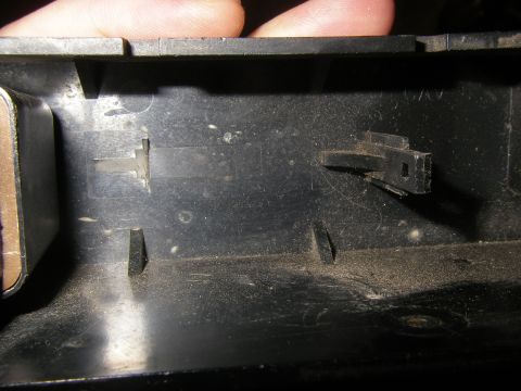 1990 Ford Bronco - Interior plastic part with connectors, likely from a vehicle's electrical system.